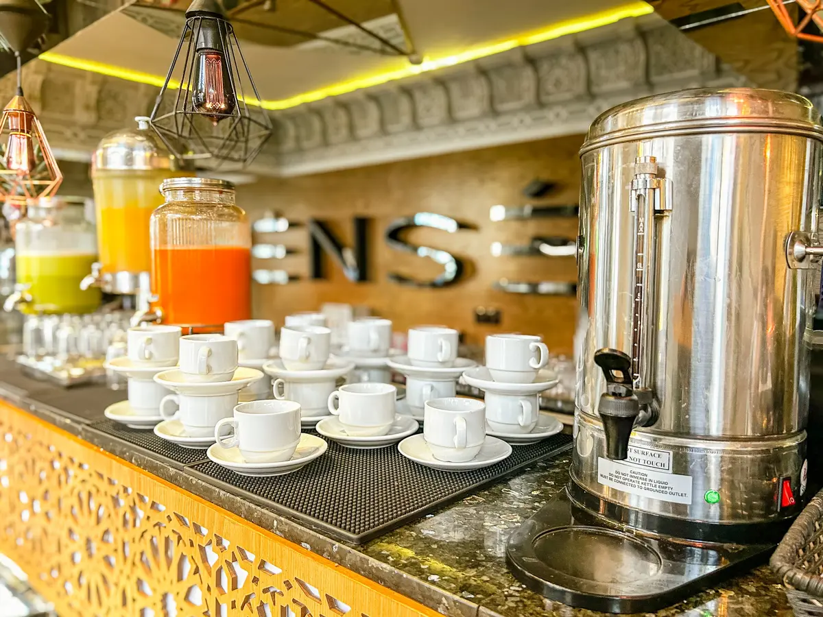 The Pensée buffet drinks counter with juice dispensers and cups